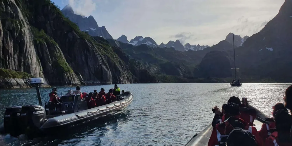 Guests taking in the steep Trollfjord walls from the RIB boat